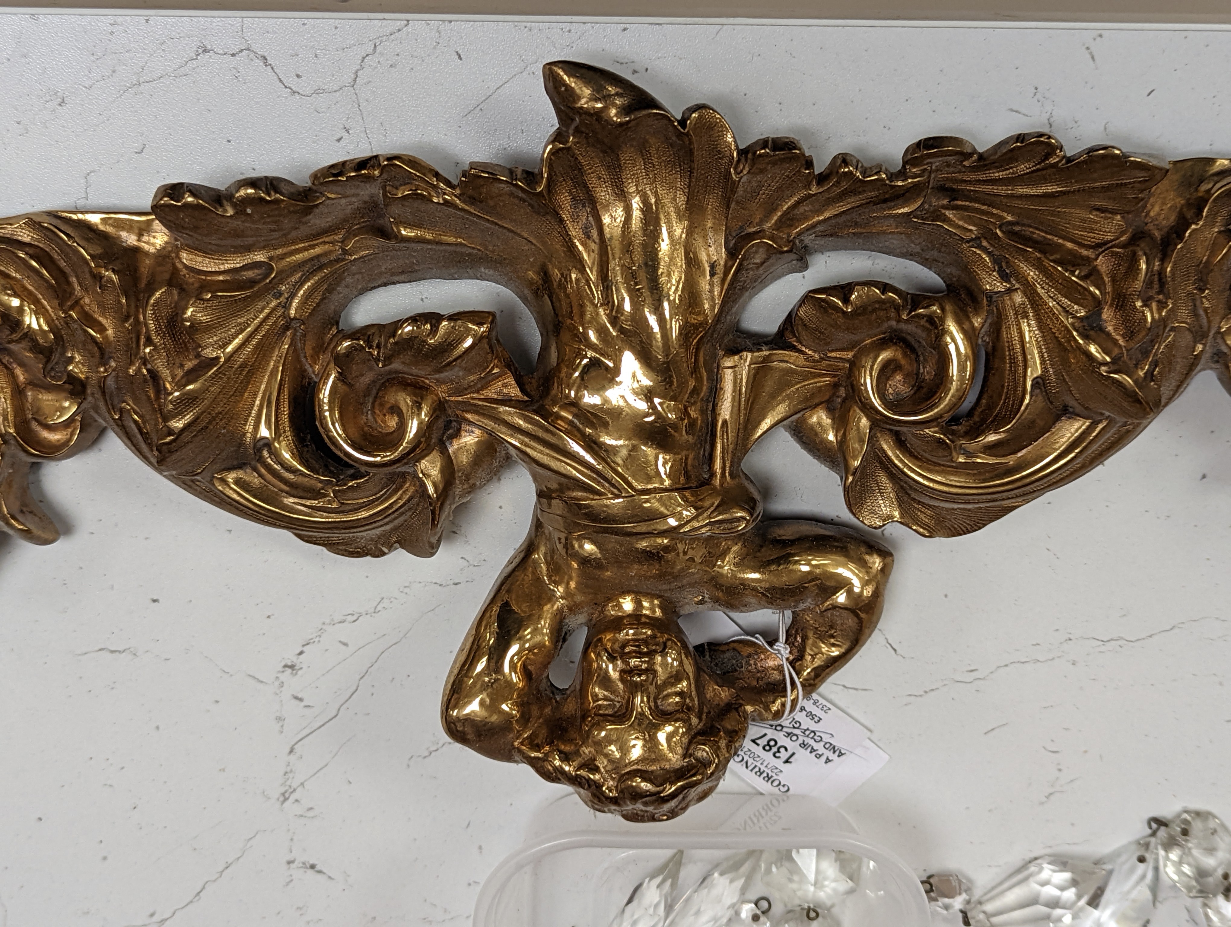 A pair of ormolu and cut glass twin branch wall lights, a bag light and a brass mount